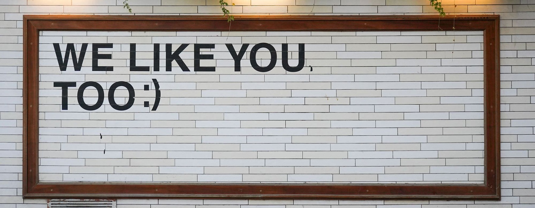 a sign on a tile wall